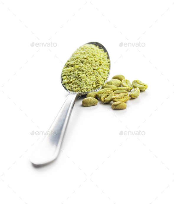 Ground green coffee and coffee beans in spoon. Unroasted coffee